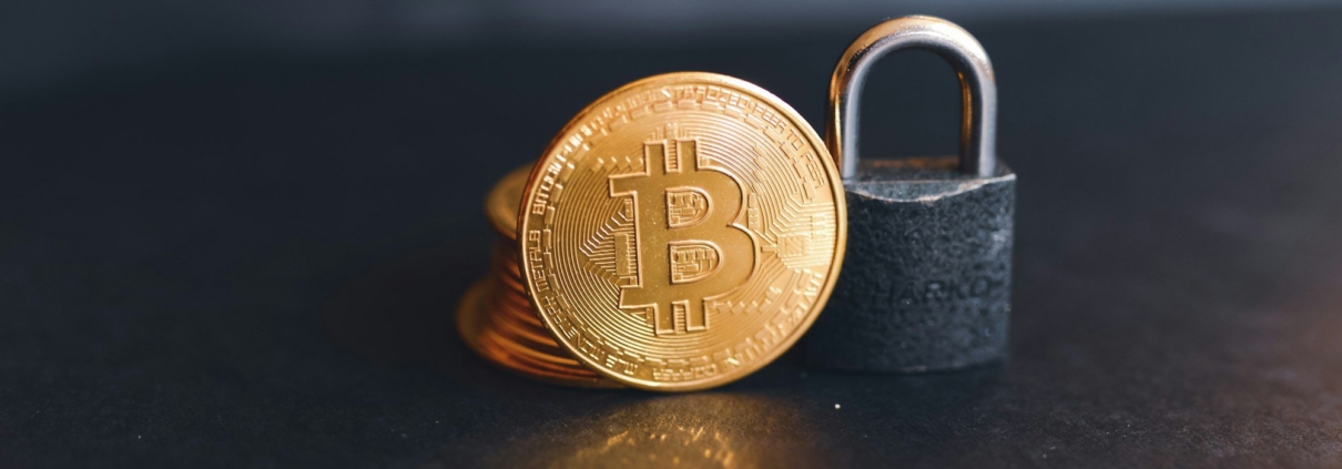 a bit coin sitting on top of a padlock