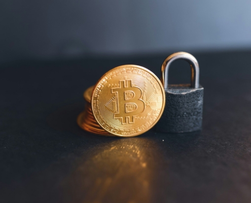 a bit coin sitting on top of a padlock