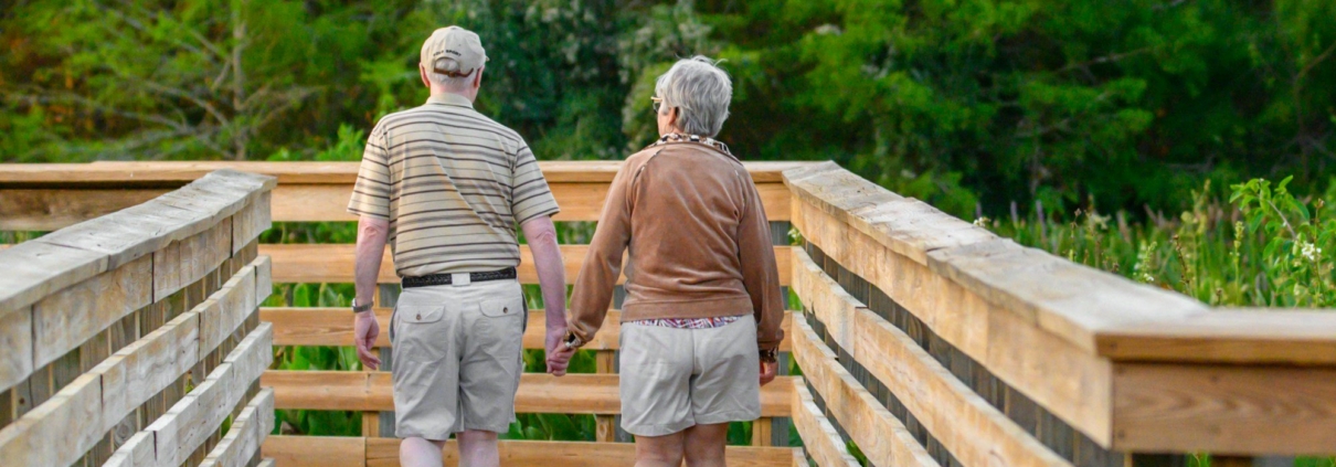 a couple of people that are walking across a bridge