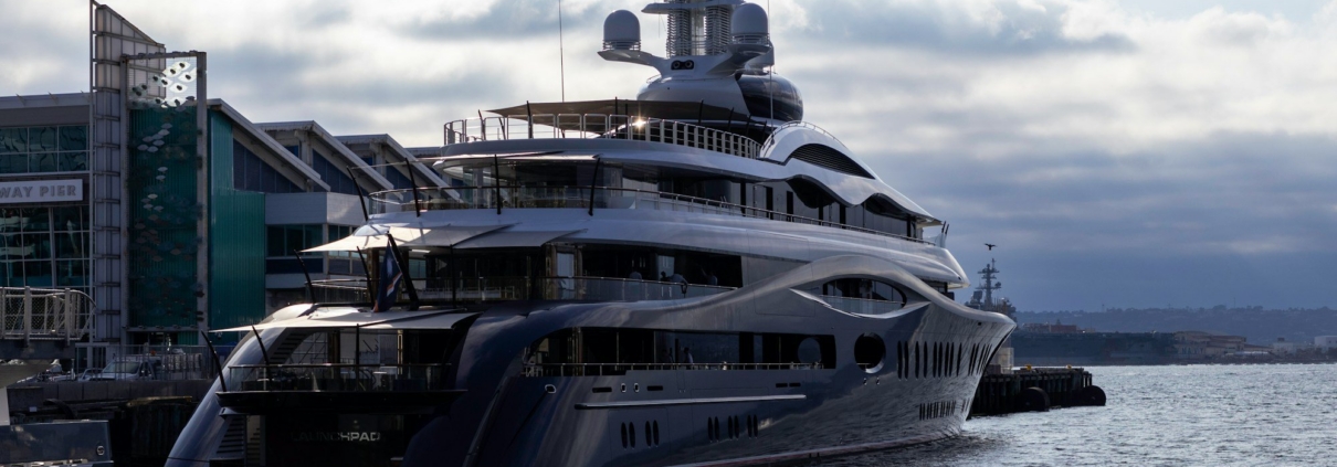 A large boat in the water next to a dock