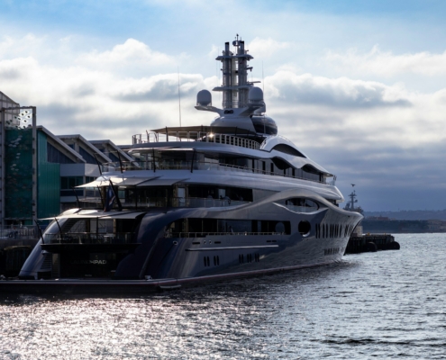 A large boat in the water next to a dock